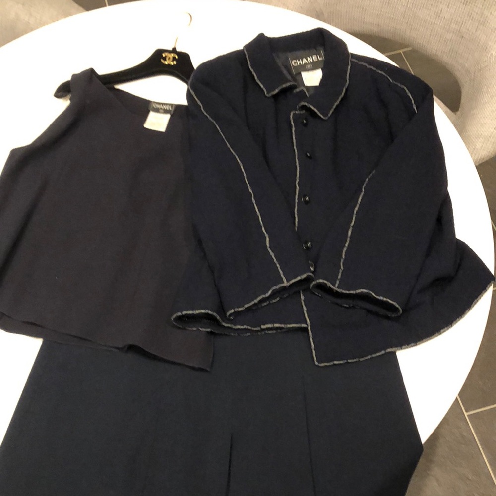 Dark Navy Chanel skirt suit with blouse and blazer.